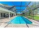 Sparkling pool surrounded by brick pavers and a screened enclosure at 4283 Southwell Way, Sarasota, FL 34241