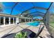 Screened in patio featuring a luxurious pool, comfortable seating, and a golf course view at 4283 Southwell Way, Sarasota, FL 34241