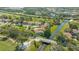 Property aerial view with a canal-front location, lush landscaping, and access to a nearby bridge at 4404 Calle Serena, Sarasota, FL 34238