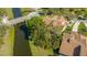 Stunning aerial view of the property showcasing the red tile roof, landscaping, and waterfront location on the canal at 4404 Calle Serena, Sarasota, FL 34238