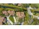 Aerial view of the property highlighting the clay tile roof, manicured lawns, and canal-front setting at 4404 Calle Serena, Sarasota, FL 34238