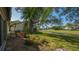 Beautiful backyard view with lush landscaping, a serene canal, and a glimpse of the surrounding golf course at 4404 Calle Serena, Sarasota, FL 34238