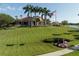 Elegant clubhouse with manicured lawn, palm trees, and an American flag waving proudly at 4404 Calle Serena, Sarasota, FL 34238