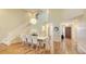 Bright dining room with high ceilings, hardwood floors, and elegant white staircase at 4404 Calle Serena, Sarasota, FL 34238