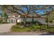 Charming home exterior featuring a tile roof, lush landscaping, and a classic mailbox at the curb at 4404 Calle Serena, Sarasota, FL 34238