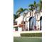 Exterior view of a building with architectural features, palm trees, and manicured greenery at 4404 Calle Serena, Sarasota, FL 34238