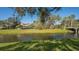 Exterior view of the property with a lush lawn sloping down to the canal and a charming bridge at 4404 Calle Serena, Sarasota, FL 34238