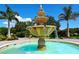 Beautiful tiered water fountain surrounded by landscaping and blue sky at 4404 Calle Serena, Sarasota, FL 34238