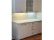 Elegant kitchen with white cabinets, quartz countertops, and soft under-cabinet lighting at 4404 Calle Serena, Sarasota, FL 34238