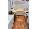 Updated kitchen with white cabinets, stainless steel appliances, and beautiful backsplash at 4404 Calle Serena, Sarasota, FL 34238