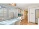 Bright kitchen nook with white table and modern cabinetry on hardwood flooring at 4404 Calle Serena, Sarasota, FL 34238