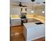 Stylish kitchen featuring white cabinets, stainless steel appliances, and a functional center island at 4404 Calle Serena, Sarasota, FL 34238