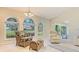 Bright living room with vaulted ceilings, comfortable seating, and large picture windows at 4404 Calle Serena, Sarasota, FL 34238