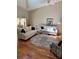 Cozy living room features neutral sofas, modern decor, and a large area rug on wood floors at 4404 Calle Serena, Sarasota, FL 34238