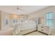 Comfortable main bedroom with large windows, neutral tones, and a ceiling fan at 4404 Calle Serena, Sarasota, FL 34238