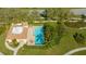 Aerial view of pool and pool house with lounge chairs surrounded by lush trees and landscaping at 4404 Calle Serena, Sarasota, FL 34238