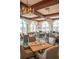 Interior of well-decorated restaurant with tray ceiling, ample seating, and views of the golf course at 4404 Calle Serena, Sarasota, FL 34238