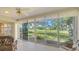Cozy sunroom with a view of lush green lawn and waterway, perfect for relaxing at 4404 Calle Serena, Sarasota, FL 34238