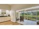 Bright sunroom with sliding glass doors offering expansive view of the green lawn at 4404 Calle Serena, Sarasota, FL 34238