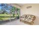 Relaxing sunroom featuring a comfortable seating area with views of the pond and greenery at 4404 Calle Serena, Sarasota, FL 34238