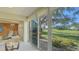 Beautiful sunroom featuring sliding glass doors with a view of the green yard and pond at 4404 Calle Serena, Sarasota, FL 34238