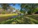 Scenic water view of the canal and bridge, framed by mature trees and verdant green space at 4404 Calle Serena, Sarasota, FL 34238