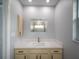 Bright bathroom featuring a modern vanity, and a large mirror reflecting the shower at 4453 Meadow Creek Cir, Sarasota, FL 34233