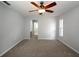 Spacious bedroom with ceiling fan and neutral carpeting at 4453 Meadow Creek Cir, Sarasota, FL 34233