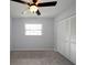 Bedroom with white closet doors, neutral walls, and a ceiling fan with an attached light at 4453 Meadow Creek Cir, Sarasota, FL 34233
