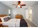 Bedroom with light gray walls, plush carpet, and a ceiling fan with attached lighting at 4453 Meadow Creek Cir, Sarasota, FL 34233