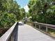 Scenic view of bridge walkway surrounded by a lush green landscape with a shaded gazebo at 4453 Meadow Creek Cir, Sarasota, FL 34233