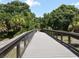Beautiful bridge walkway surrounded by a lush green landscape perfect for morning walks at 4453 Meadow Creek Cir, Sarasota, FL 34233