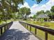 Scenic community park with a wooden bridge, pavilion, and playground area for residents to enjoy at 4453 Meadow Creek Cir, Sarasota, FL 34233