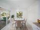 Sunlit dining area with seating for six and sliding glass doors to the pool at 4453 Meadow Creek Cir, Sarasota, FL 34233
