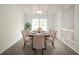 Bright dining room with a large window, vaulted ceiling, modern chandelier and six chairs at 4453 Meadow Creek Cir, Sarasota, FL 34233