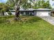 Charming single-story home features a well-manicured lawn, attached garage, and inviting curb appeal at 4453 Meadow Creek Cir, Sarasota, FL 34233