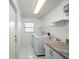 Convenient laundry room with sink and granite countertops at 4453 Meadow Creek Cir, Sarasota, FL 34233