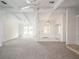 The expansive living room features a vaulted ceiling, neutral carpet, and large windows at 4453 Meadow Creek Cir, Sarasota, FL 34233