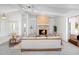 Spacious living room features a brick fireplace, modern seating, and a large sliding glass door at 4453 Meadow Creek Cir, Sarasota, FL 34233