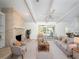 Spacious living room featuring a brick fireplace, neutral color palette, and access to the outdoor space at 4453 Meadow Creek Cir, Sarasota, FL 34233