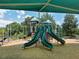 The playground features a set of slides and play structure under a green canopy, offering shade and fun at 4453 Meadow Creek Cir, Sarasota, FL 34233