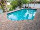 Sparkling private pool, surrounded by brick pavers and lush landscaping at 4453 Meadow Creek Cir, Sarasota, FL 34233