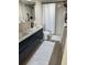 Contemporary bathroom featuring a double sink vanity, a large mirror, and a sleek shower with a black showerhead at 4460 Fairways Blvd # 304, Bradenton, FL 34209