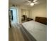 Cozy bedroom featuring a mirrored closet, ceiling fan, and wood laminate flooring at 4460 Fairways Blvd # 304, Bradenton, FL 34209