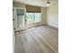Bright bedroom featuring wood-look flooring, a ceiling fan, and a glass door to a balcony at 4460 Fairways Blvd # 304, Bradenton, FL 34209