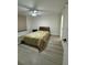 Well-lit bedroom featuring wood-look floors, a ceiling fan, and a comfortable bed at 4460 Fairways Blvd # 304, Bradenton, FL 34209