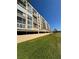 Multi-story building featuring open-air parking with well-maintained green space and landscaping at 4460 Fairways Blvd # 304, Bradenton, FL 34209