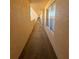 Hallway view with durable flooring, textured walls, and natural light offering a clean transit space at 4460 Fairways Blvd # 304, Bradenton, FL 34209