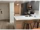 Open-concept kitchen featuring gray cabinets, stainless steel appliances, quartz countertop, and seating at the bar at 4460 Fairways Blvd # 304, Bradenton, FL 34209