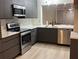 Modern kitchen featuring sleek cabinetry, stainless steel appliances, and a breakfast bar pass through at 4460 Fairways Blvd # 304, Bradenton, FL 34209